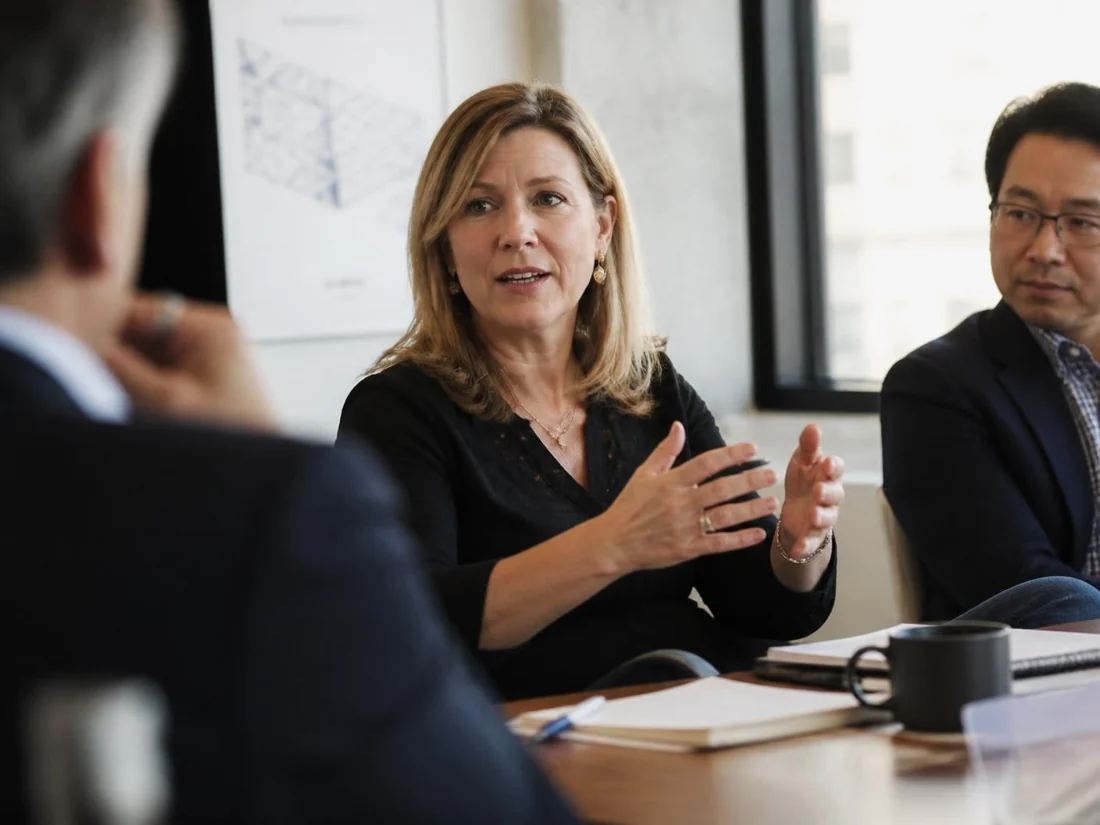 A woman contributing her perspective during a leadership meeting