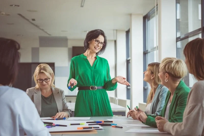 A woman leading a collaborative conversation with her colleagues